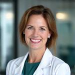 Portrét Dr. Elišky Novákové, usmívající se lékařky ve středním věku